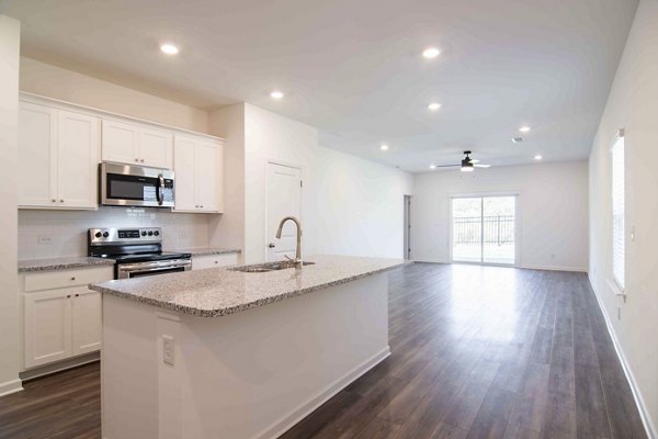 Modern kitchen with stainless steel appliances at Summerwell Deerhaven Apartments