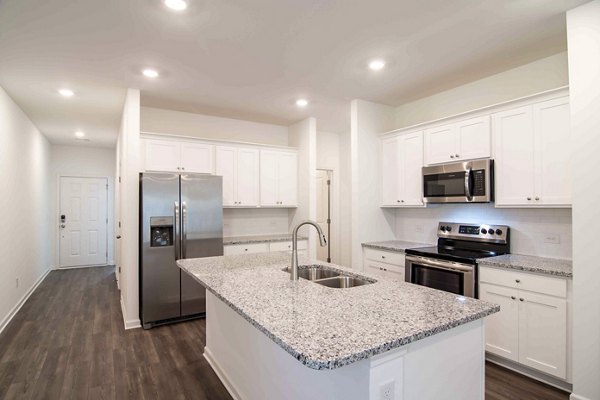 Modern kitchen with stainless steel appliances at Summerwell Deerhaven Apartments