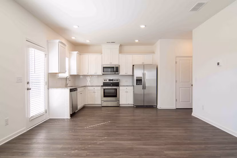 Modern kitchen with stainless steel appliances at Summerwell Deerhaven Apartments
