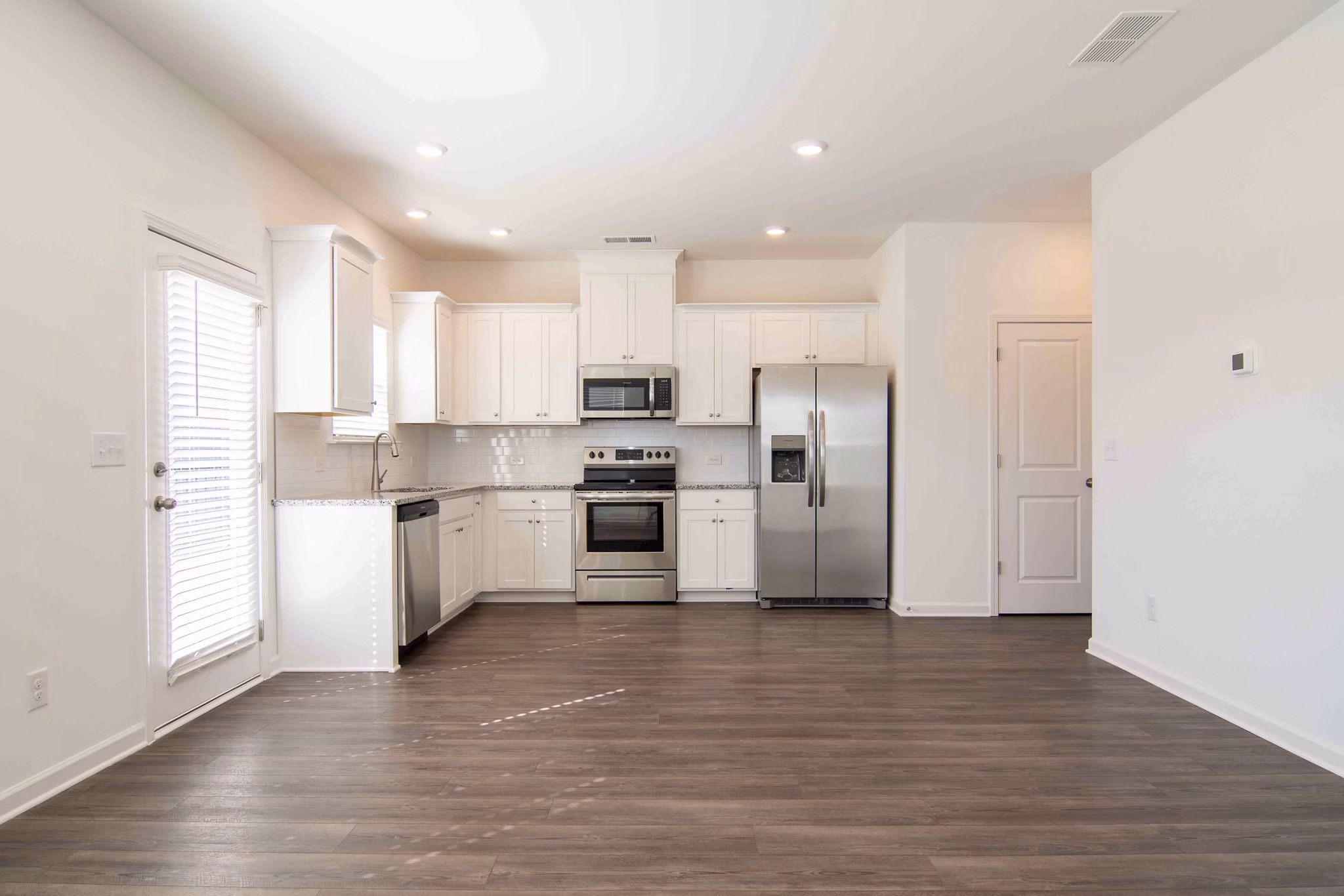 Modern kitchen with stainless steel appliances at Summerwell Deerhaven Apartments