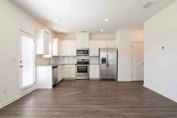 Modern kitchen with stainless steel appliances at Summerwell Deerhaven Apartments