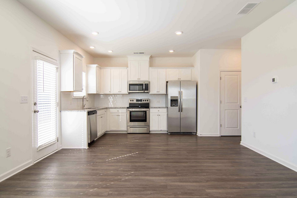 Modern kitchen with stainless steel appliances at Summerwell Deerhaven Apartments