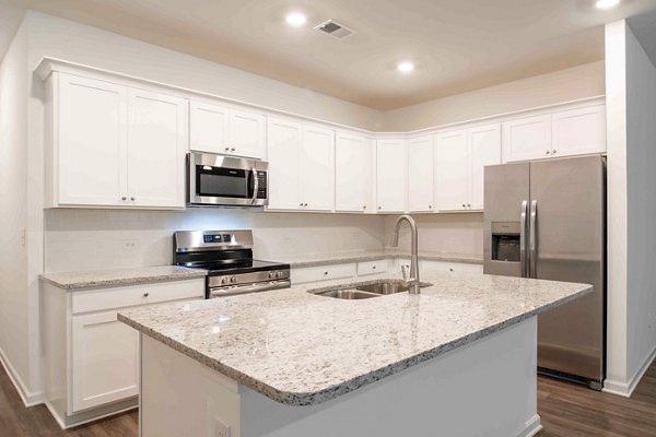 Summerwell Deerhaven Apartments: Modern kitchen with sleek countertops and stainless steel appliances