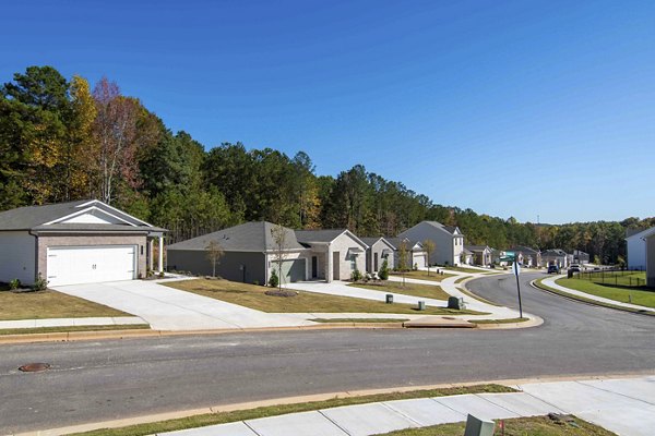 Summerwell Deerhaven: Scenic view at luxury apartments with lush greenery and outdoor pathways