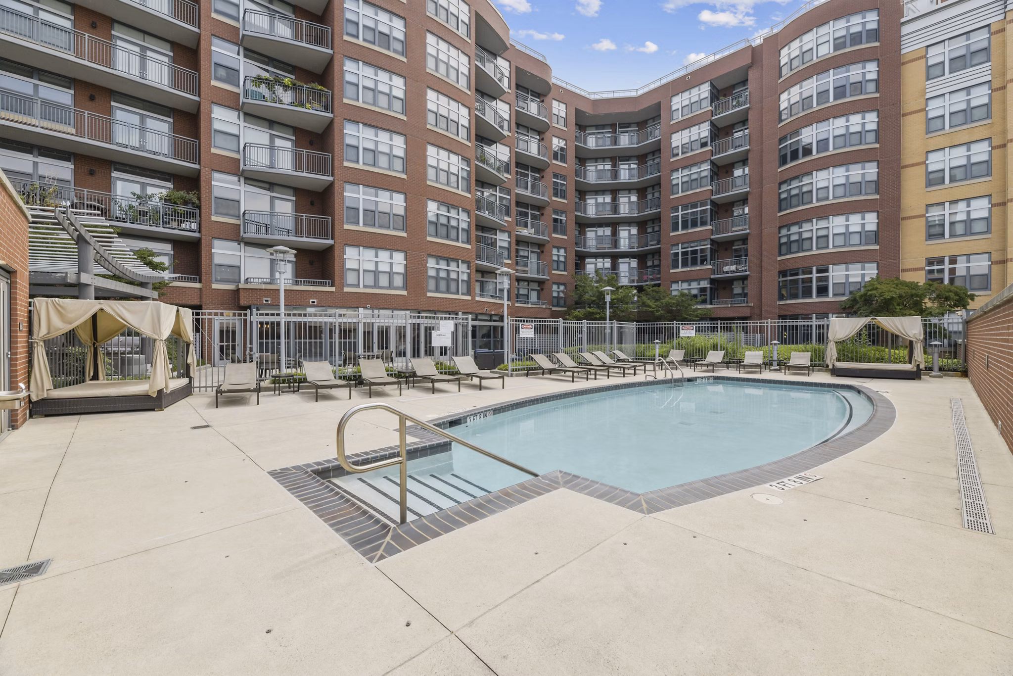 Modern pool area featuring sun loungers at Jasper Columbia Pike Apartments