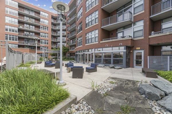 Courtyard with lush seating area at Jasper Columbia Pike Apartments, offering a tranquil outdoor retreat for residents