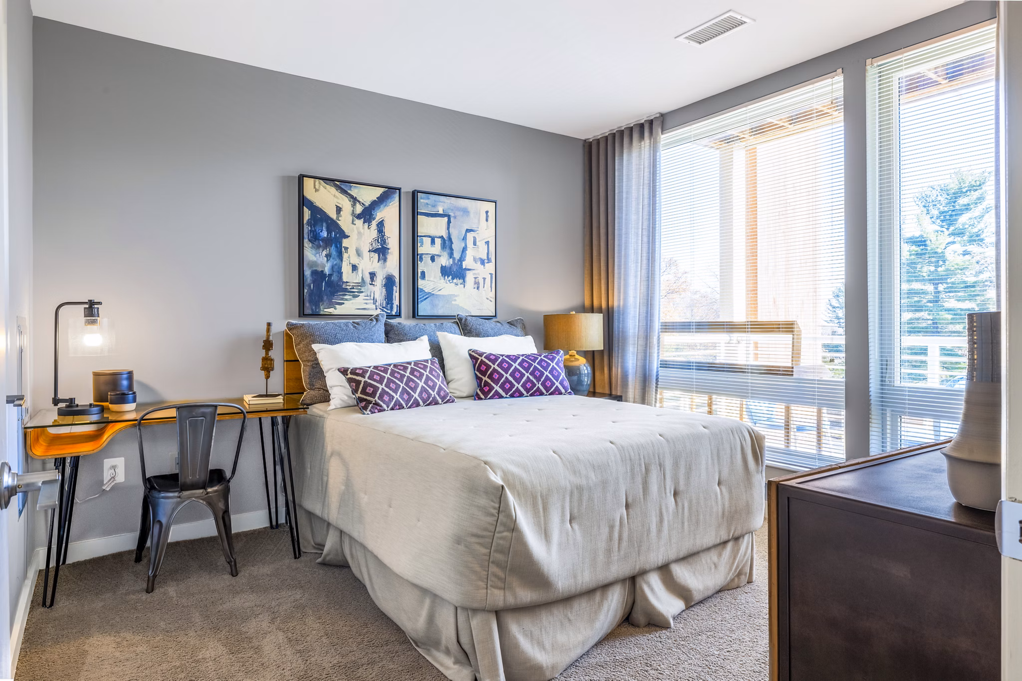 Elegant bedroom with modern decor at VY Reston Heights luxury apartments, featuring plush bedding and ample natural light for relaxation