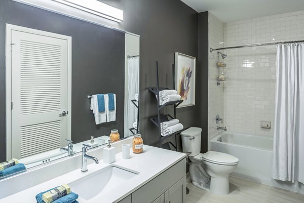 Modern bathroom with sleek fixtures and ample lighting at VY Reston Heights Apartments