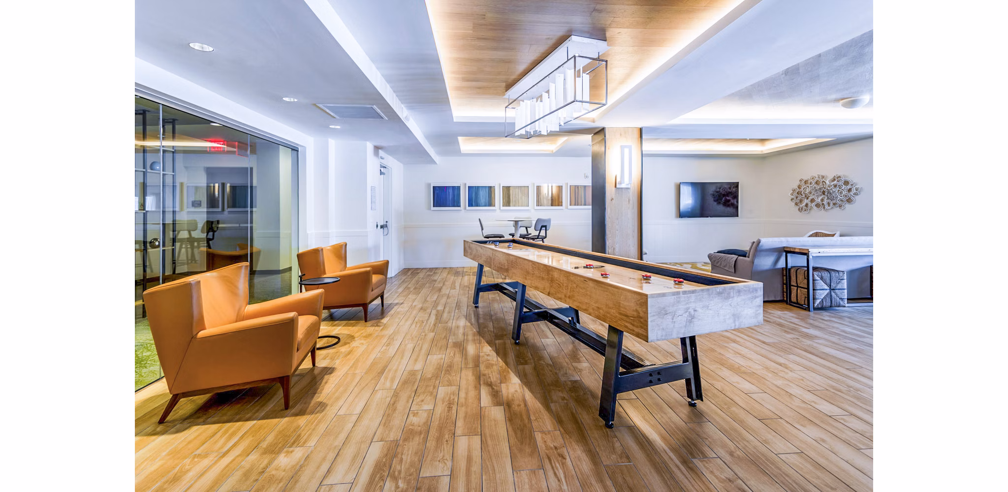 Clubhouse game room with pool table and seating at VY Reston Heights Apartments, ideal for social gatherings and leisure activities