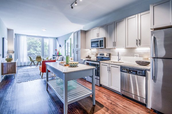 Modern kitchen with stainless steel appliances and granite countertops in VY Reston Heights Apartments