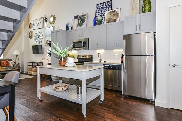 Modern kitchen featuring stainless steel appliances and granite countertops in VY Reston Heights Apartments