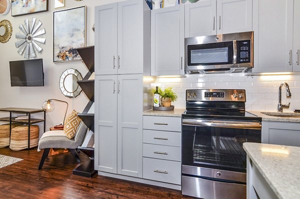 Modern kitchen with sleek cabinetry and stainless steel appliances in VY Reston Heights Apartments, luxury living in Reston Heights