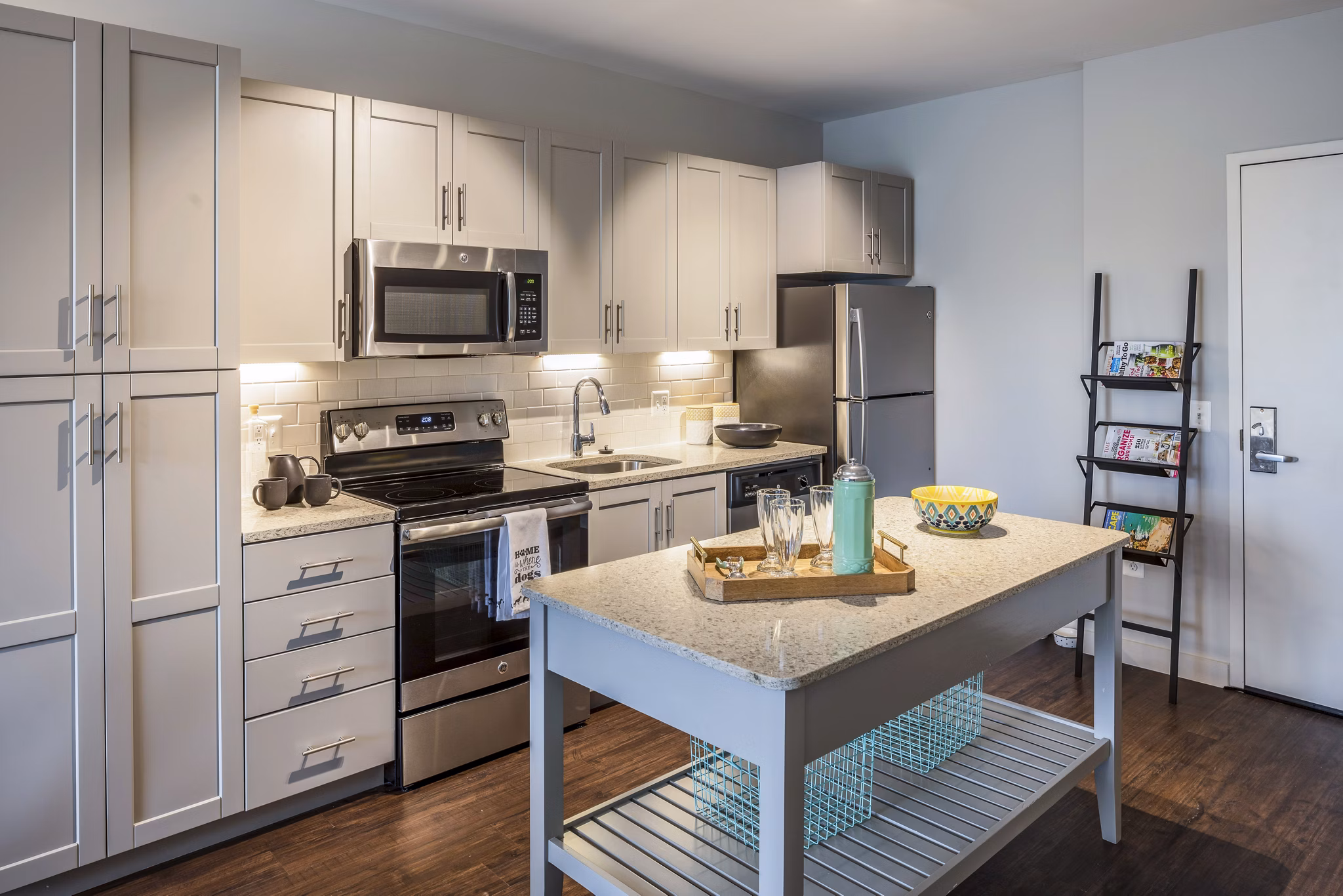 Modern kitchen with stainless steel appliances and marble countertops at VY Reston Heights Apartments