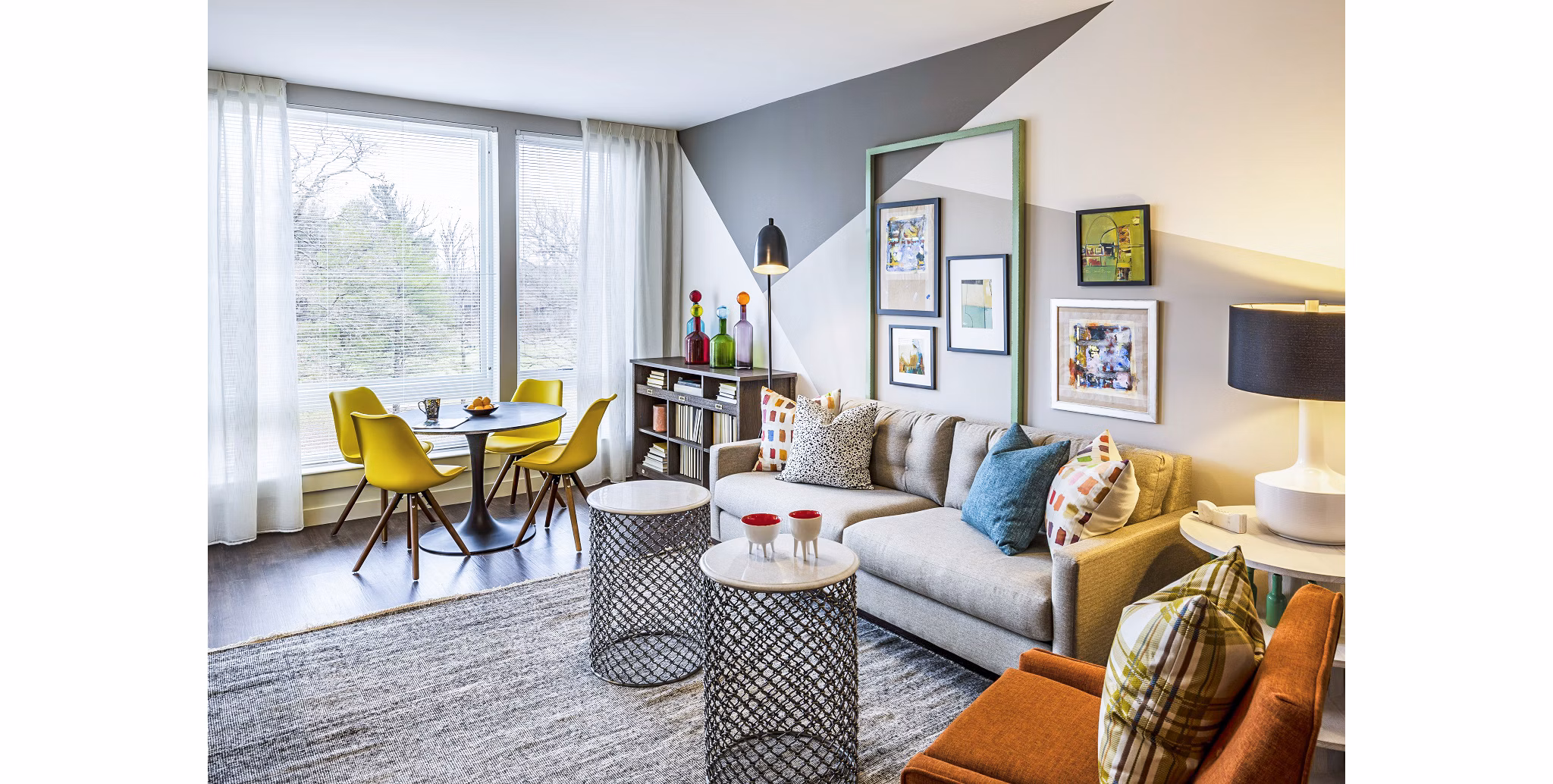 Living room with modern dÃ©cor and large windows at VY Reston Heights luxury apartments