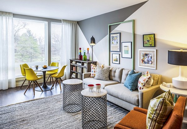 Living room with modern dÃ©cor and large windows at VY Reston Heights luxury apartments