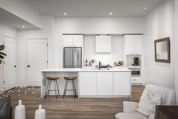 Modern kitchen with stainless steel appliances in Bluff at Boulder Commons Apartments