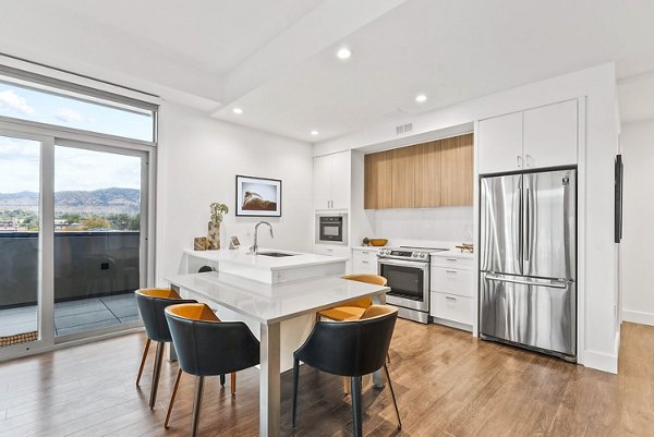 Bluff at Boulder Commons: Modern kitchen with sleek countertops and stainless steel appliances in luxury apartments