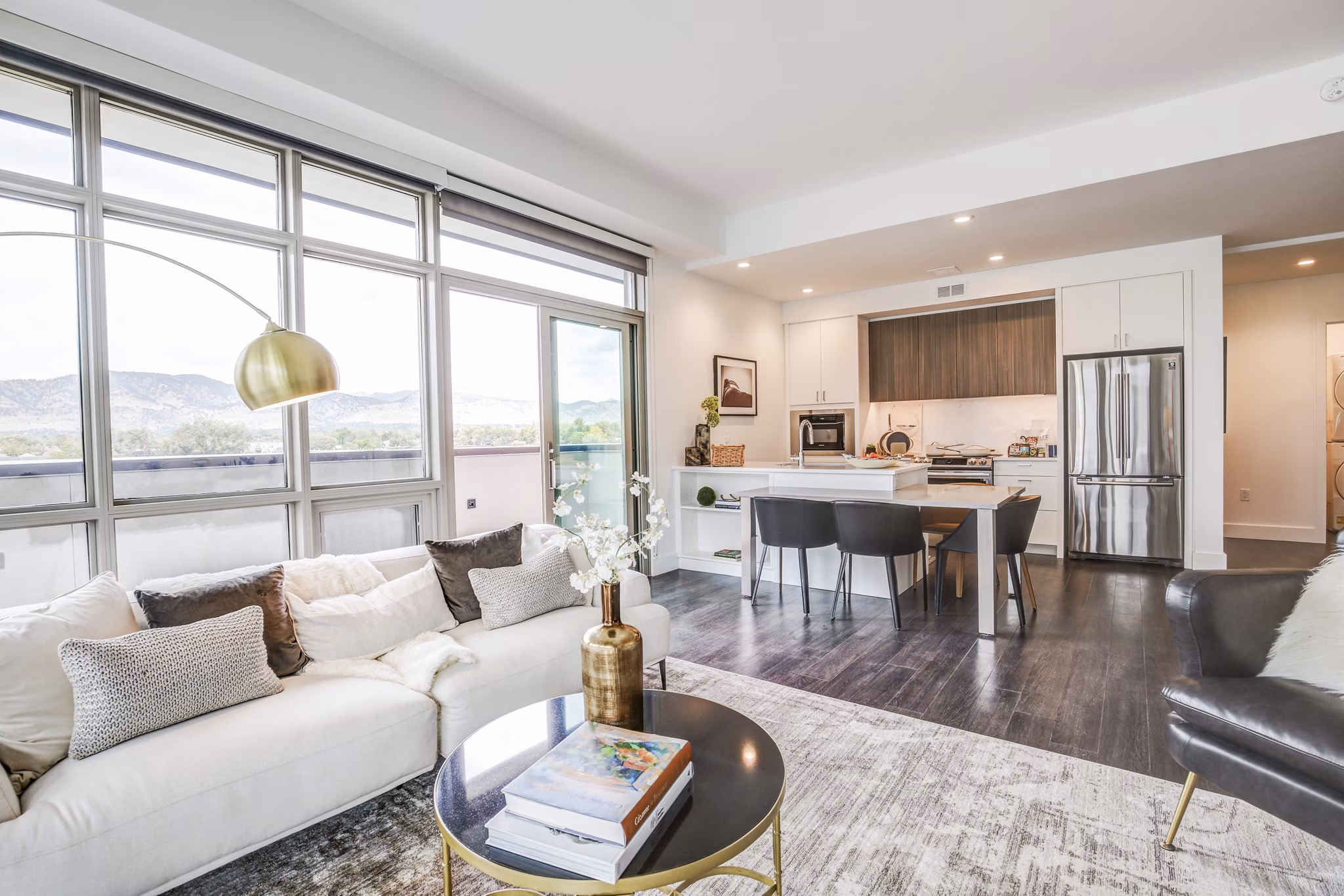 Modern living room with cozy seating at Bluff at Boulder Commons Apartments