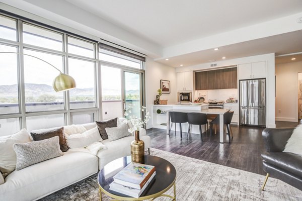 Modern living room with cozy seating at Bluff at Boulder Commons Apartments