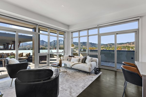 Spacious living room with modern furnishings at Bluff at Boulder Commons Apartments