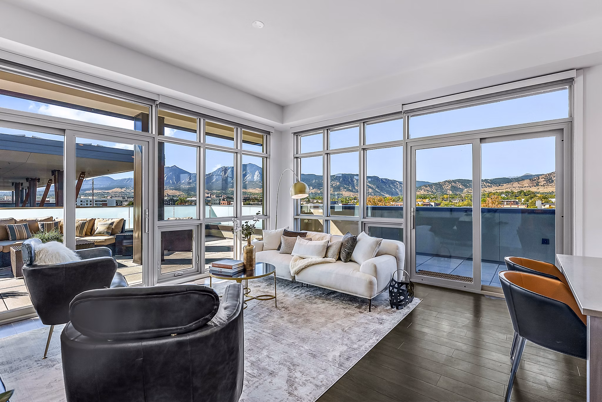 Spacious living room with modern decor and large windows at Bluff at Boulder Commons Apartments