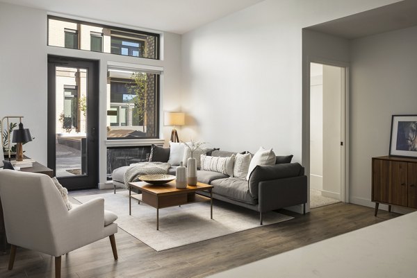 Spacious living room with modern decor in Bluff at Boulder Commons Apartments, offering luxury comfort and style