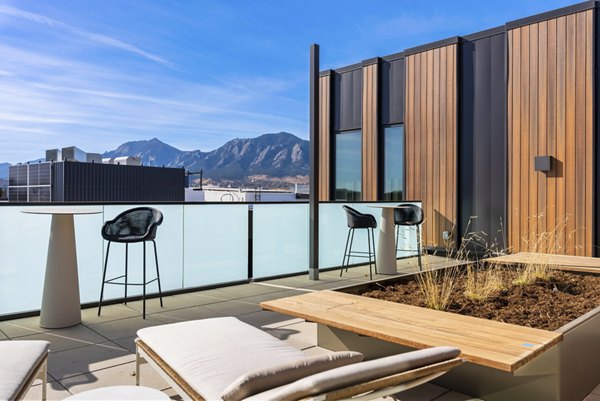 Expansive rooftop deck with modern seating at Bluff at Boulder Commons Apartments, enhancing urban living with scenic views