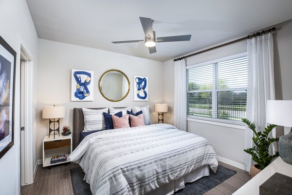 Bedroom featuring modern furnishings and large windows at Allora Alamo Heights Apartments