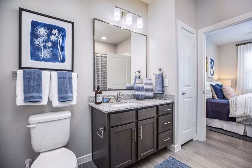 Modern bathroom featuring sleek fixtures and marble countertops in Allora Alamo Heights Apartments