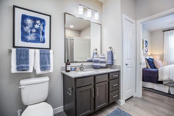Modern bathroom featuring sleek fixtures and marble countertops in Allora Alamo Heights Apartments