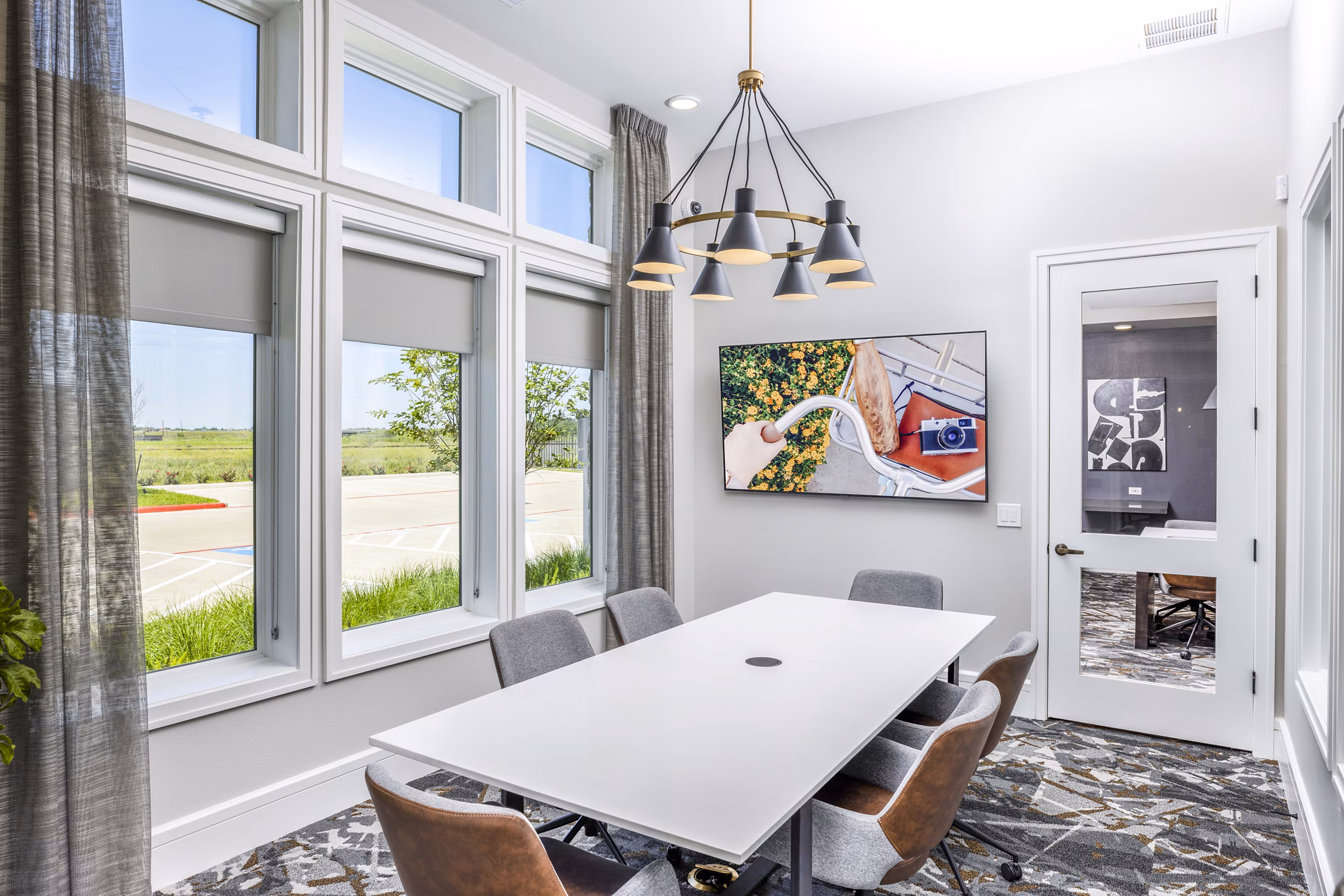 Modern clubhouse meeting facility with sleek furnishings at Allora Alamo Heights Apartments