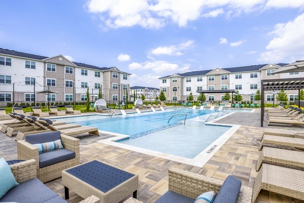 Poolside relaxation area with luxury sun loungers at Allora Alamo Heights Apartments in San Antonio