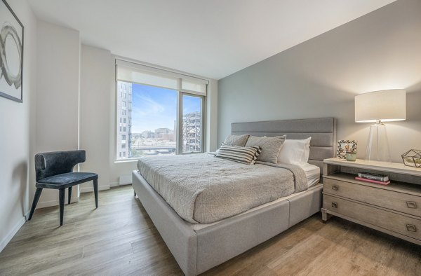 Bedroom featuring modern decor and ample natural light at The Alyx Apartments, luxury living by Greystar