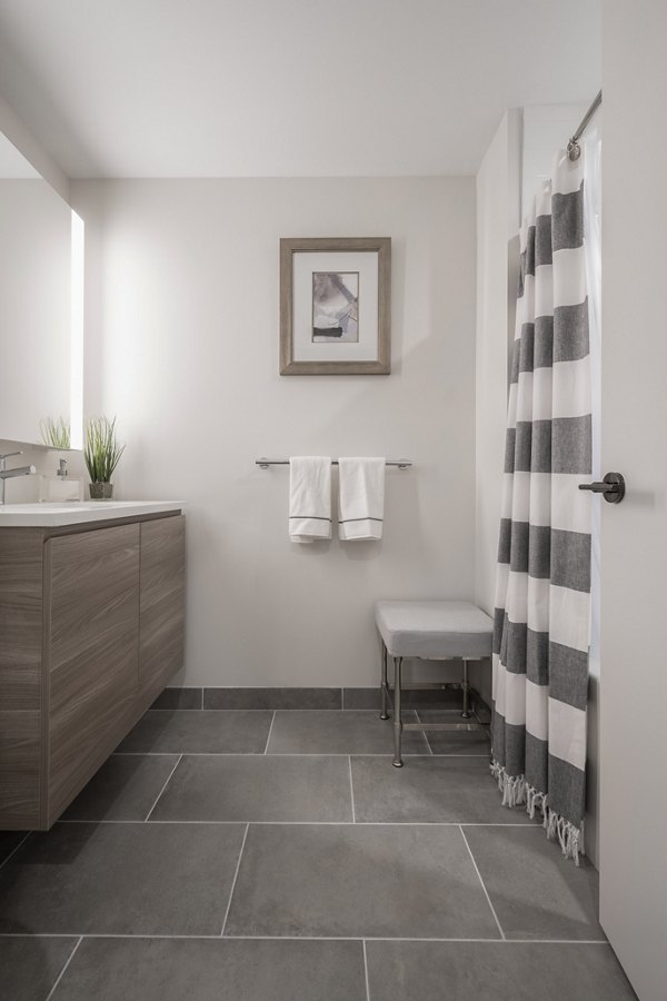 Bathroom featuring modern fixtures and elegant design in The Alyx Apartments