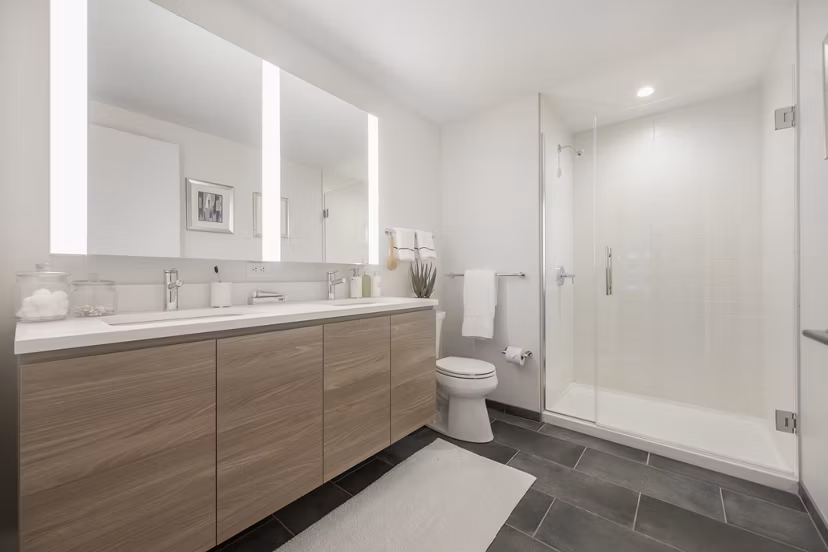 Modern bathroom with sleek fixtures and marble countertops at The Alyx Apartments