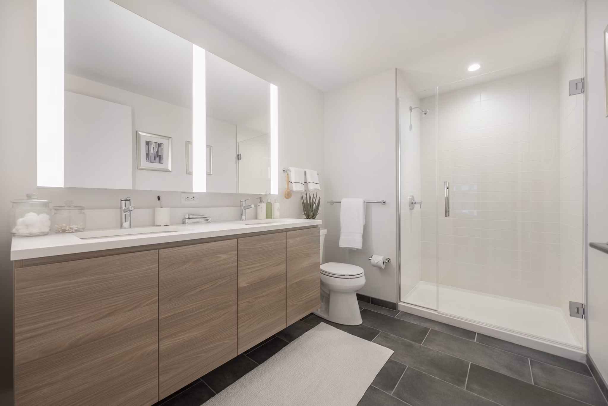 Modern bathroom with sleek fixtures and marble countertops at The Alyx Apartments