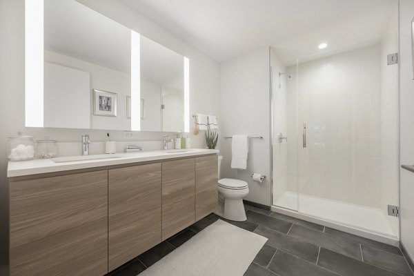 Modern bathroom with sleek fixtures and marble countertops at The Alyx Apartments
