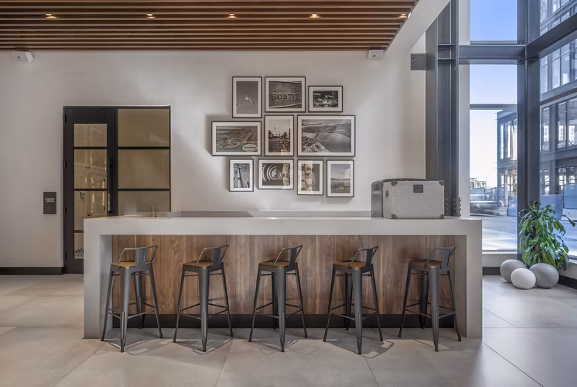 Clubhouse with modern decor and gaming area at The Alyx Apartments, offering luxury amenities in a vibrant community