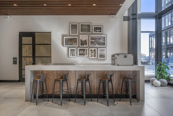 Clubhouse with modern decor and gaming area at The Alyx Apartments, offering luxury amenities in a vibrant community