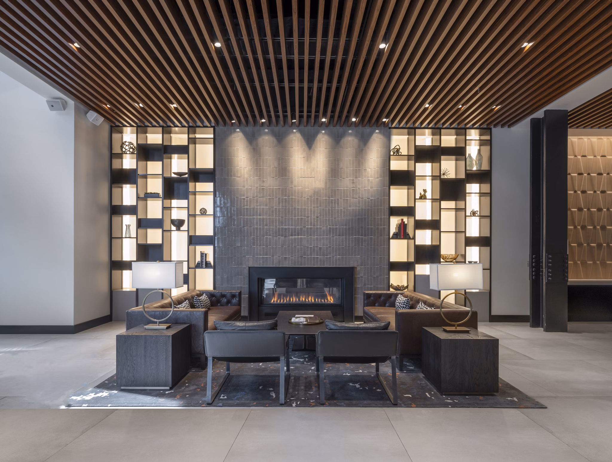 Clubhouse featuring modern design and seating areas at The Alyx Apartments