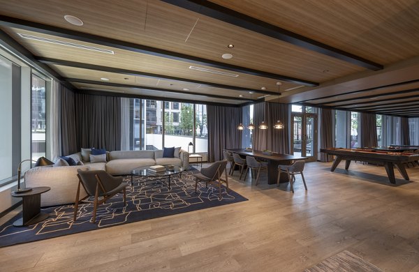 The Alyx Apartments: Modern clubhouse featuring stylish seating areas and vibrant decor in a luxury community