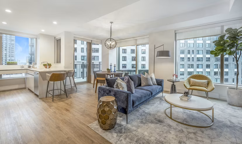 Contemporary living room with stylish decor and large windows at The Alyx Apartments