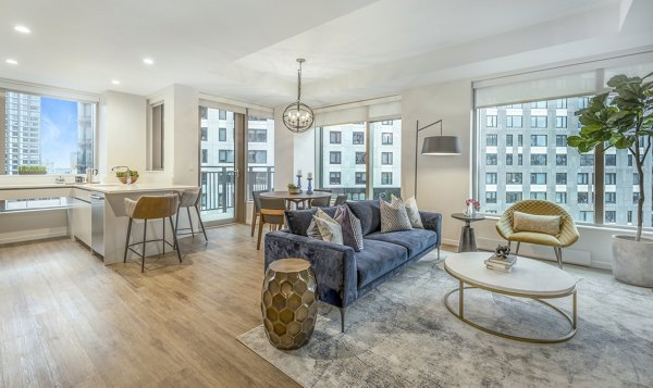 Contemporary living room with stylish decor and large windows at The Alyx Apartments