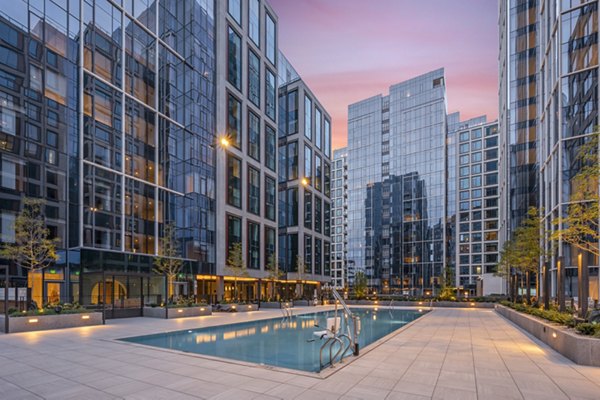 Luxurious pool area with stylish seating at The Alyx Apartments, perfect for relaxation and socializing