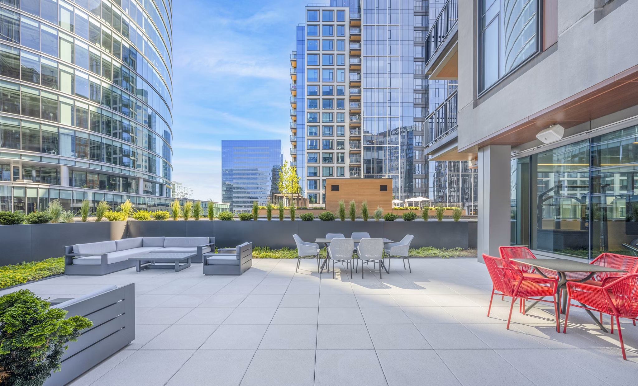Courtyard featuring modern seating and lush landscaping at The Alyx Apartments, a luxury residence