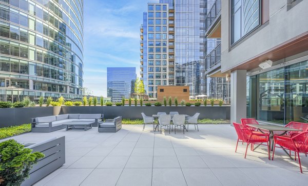 Courtyard featuring modern seating and lush landscaping at The Alyx Apartments, a luxury residence