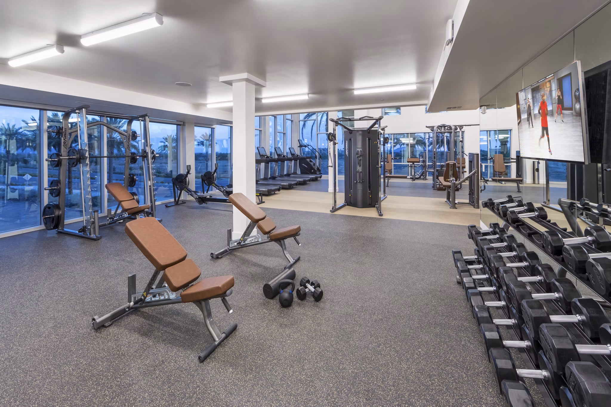 State-of-the-art fitness center with modern equipment at Sunela Apartments, luxury living by Greystar