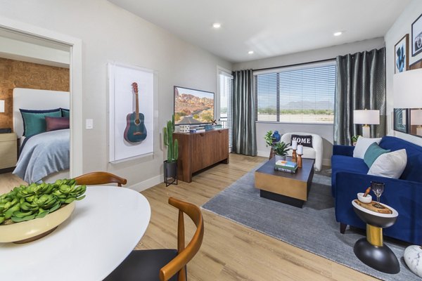 Modern living room with stylish furnishings at Sunela Apartments, featuring comfortable seating and expansive windows