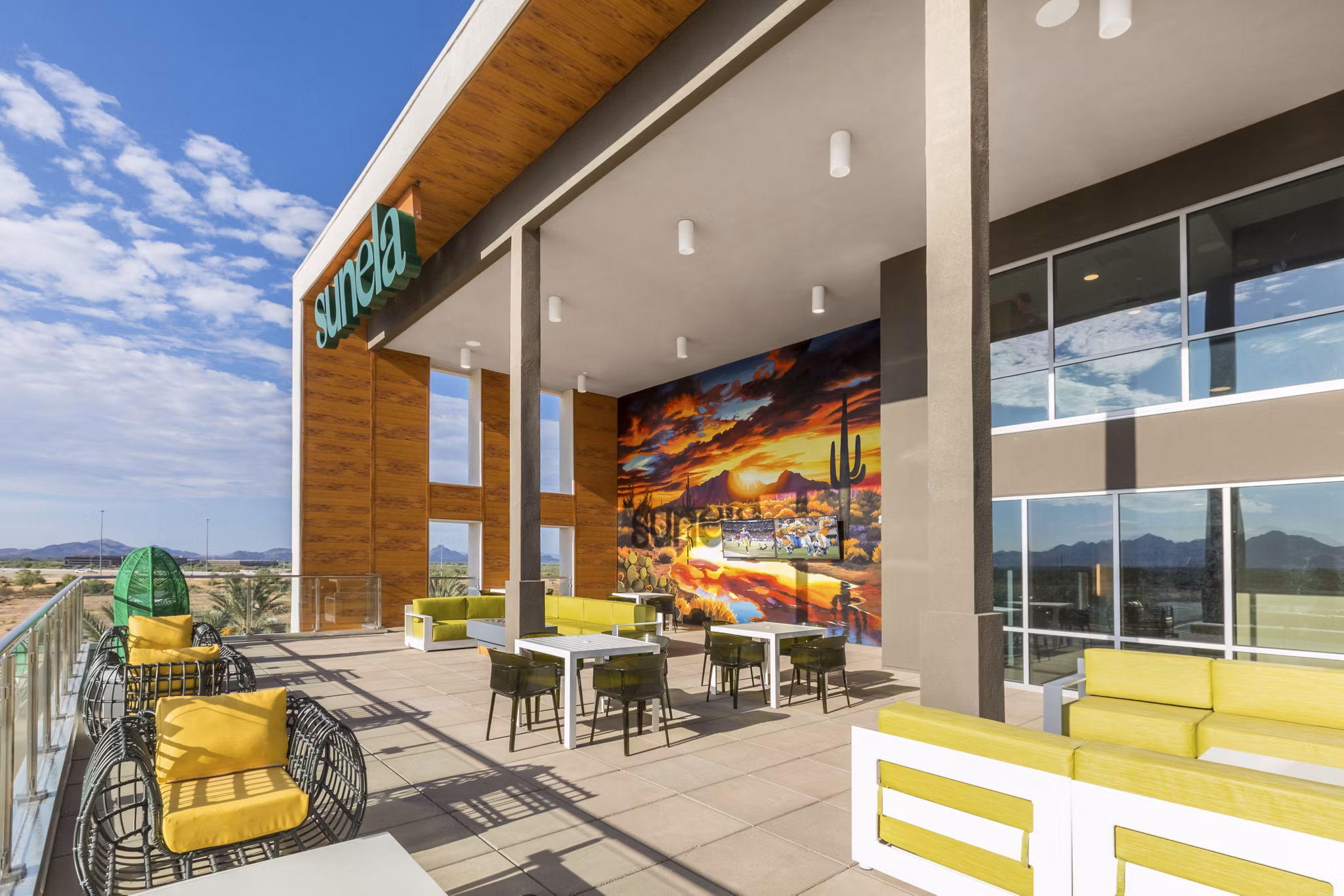 Patio space with cozy lounge furniture at Sunela Apartments, perfect for outdoor relaxation in luxury living