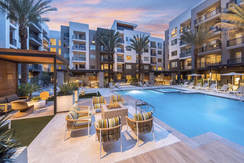 Inviting pool area with lounge chairs at Sunela Apartments, a Greystar luxury property